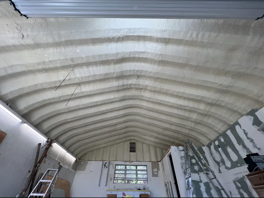 Spray polyurethane foam applied to the underside of a metal roof deck in Thatcher